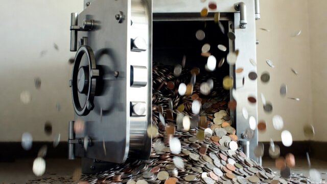 Open vault releasing a flood of golden cryptocurrency coins, representing token unlocks adding supply pressure